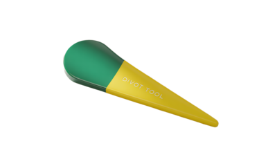 Green and Yellow Divot Tool on Beige Surface, Product Photography for Website or Catalog