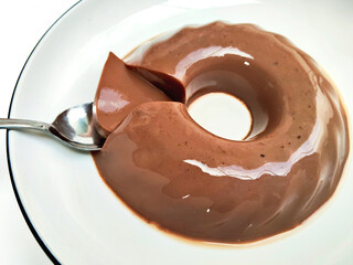 A Close-Up of a Spoon Lifting a Piece of Pudding
