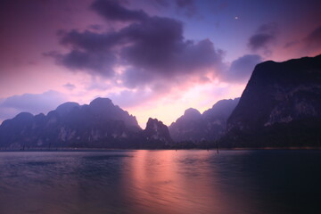 Limestone mountain landscape with reflection in water in Ratchaprapha Dam (Cheow Lan Dam) Khao Sok national park , Surat Thani province , THAILAND
