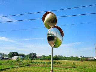 convex mirror, rural landscape, rice fields, blue sky, reflection, agriculture, outdoor, Central Java, Indonesia.