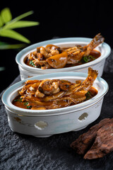 Two bowls of delicious braised fish dishes with rich sauce, presented in an appetizing way.