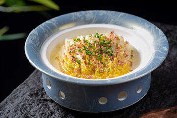 A plate of steamed Chinese cabbage topped with chopped garlic and bacon, presenting a savory and appetizing dish.