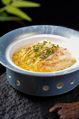 A bowl of steamed Chinese cabbage topped with savory ingredients, presented in an elegant decorative bowl.
