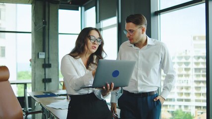 Business colleagues arguing about something while working together in a modern office with large windows and a scenic view. - Powered by Adobe