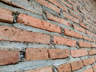 Angled Perspective of a Rough Textured Red Brick Wall