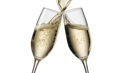 Two Champagne Flutes Toasting and Overflowing with Bubbly Drink