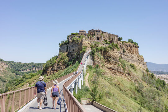 A Couple Tourists Walking Towards Civita di Bagnoregio, Italy