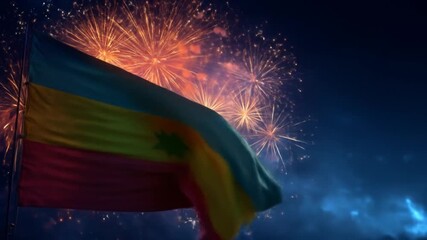 A national flag billows in the night wind, illuminated by a vibrant fireworks display exploding behind it, creating a festive and patriotic scene