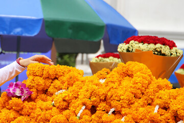 Marigold flower garlands offered for worship at the Erawan Shrine in Bangkok, Thailand.