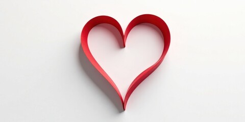 A delicate red ribbon shaped into a heart symbol, elegantly displayed on a pristine white background, conveying a message of love and affection