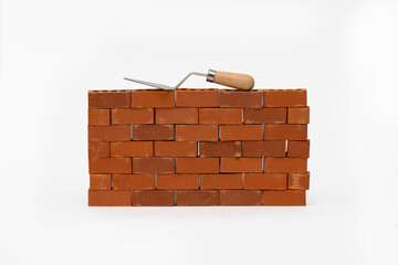Construction site on a brick wall. Building a miniature tower from bricks. Construction materials and tools