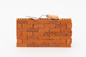 Construction site on a brick wall. Building a miniature tower from bricks. Construction materials...