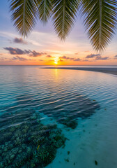 Experience paradise with this stunning tropical sunset over crystal clear waters and coral reefs, idyllic getaway