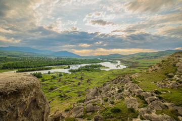 Scenic sunset views looking across the Kura River from the top of the ancient rock town of Uplistsikhe near the city of Gori, Georgia © hyserb
