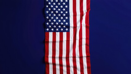 Fototapeta premium American flag draped vertically on a dark blue background