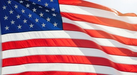 Obraz premium American Flag Waving in the Wind Under a Bright Sky