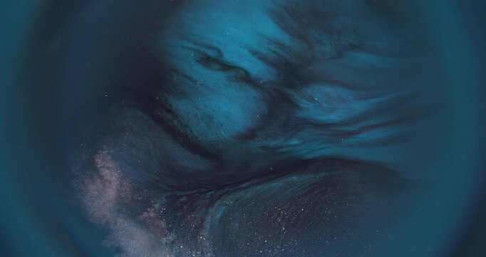 Spark glitter paint. Blur ripple background. Defocused blue color fluid water texture shiny liquid floating on dark black abstraction.