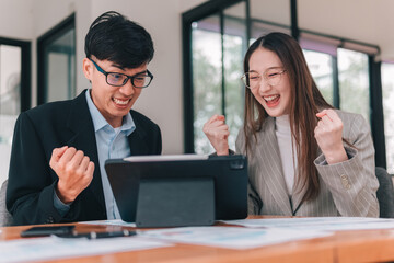 Joyful celebration of success with colleagues in modern office engaging team collaboration positive work environment