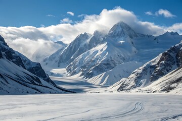 Fototapeta premium Majestic snow covered mountains under a cloudy blue sky