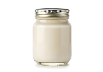 A simple glass jar filled with a creamy white substance on an isolated white background creating a minimalist food storage scene in a modern kitchen.