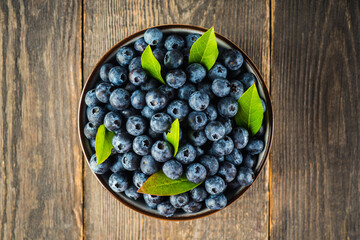 Fresh ripe garden blueberries in ceramic bowl. Summer berries.
