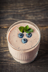 Blueberry and bananas smoothie on the rustic background. Selective focus.