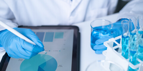 Professional scientist working writing experiment research results on tablet document for data analysis chemist hospital new discovery in genetic future planning innovation biotechnology chemical