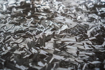 Abstract monochrome texture forged carbon broken fragments and geometric shapes. The interplay of light and shadow creates a sense of depth and motion. Ideal for modern backgrounds and designs.