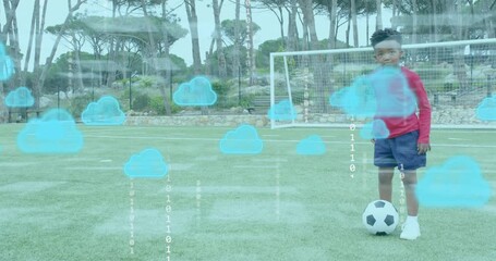 Boy practicing ball control taps on soccer turf activating digital clouds, binary code overlay - Powered by Adobe