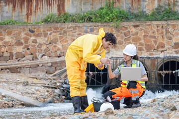 Field Scientists Collecting Water Samples near Industrial Area, Environmental Scientists Collecting Water Samples at Coastal Site, Researchers Testing Water Quality in Natural Lake