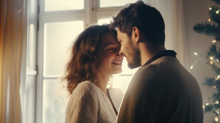 Loving couple celebrating Christmas at home. Man and woman in a seasonal winter interior. The concept of holidays.