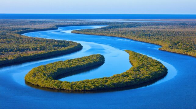Aerial view of the Guayas River in Ecuador with lush green vegetation and bright blue waters