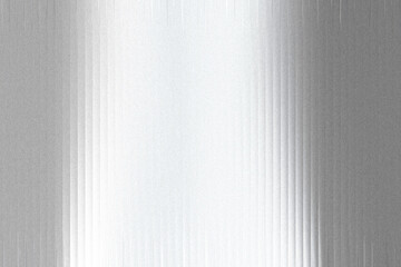 A textured metallic surface with a gradient of light and shadow, featuring vertical lines and a grainy, frosted appearance