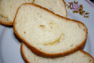 Smiling piece of bread lies on a plate, effect of pareidolia or apophenia