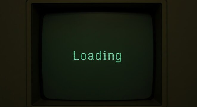 Vintage computer monitor displaying a loading screen with green text, evoking a sense of retro technology and digital progress