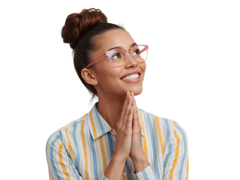 Optimistic young woman with glasses and folded hands expressing hope on isolated background