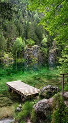 Fototapeta premium Tranquil wooden pier on a shimmering emerald lake nestled in a lush forest.
