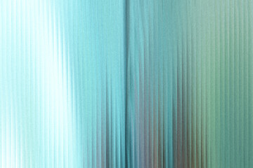 Obraz premium A shimmering abstract background with vertical lines of light blue and green, creating a sense of depth and movement