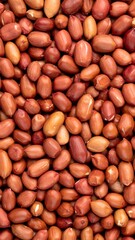 Close-up view of numerous reddish-brown peanuts