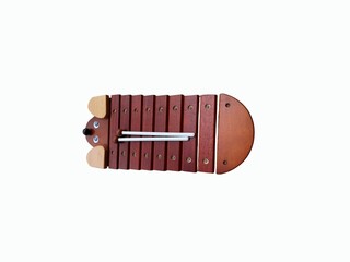 The white background in the picture is a xylophone made of wood with a brown center and a Cream color top and a brown tail. It is a percussion instrument made of wood and used as an accomp