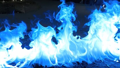 Vivid blue flames dance and swirl in a mesmerizing display of fire.