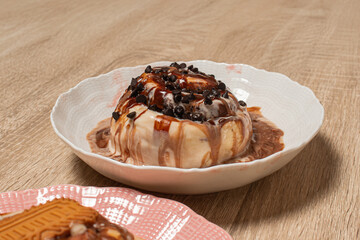 A close up of a gourmet cinnamon roll topped with chocolate chips
