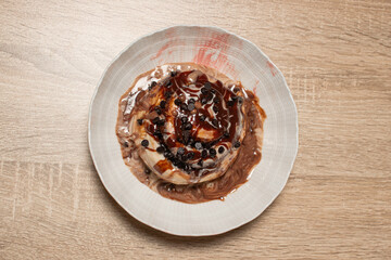 Top down view of a chocolate chip cinnamon roll in a bowl
