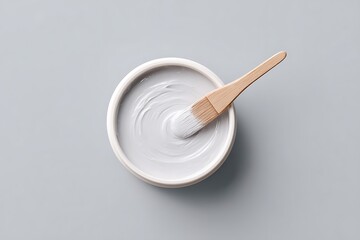 Product smear of creamy clay mask with spatula resting gently