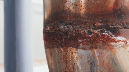 This close-up view highlights rust accumulation on a metal structure, revealing the effects of...