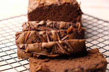 Chocolate brownies sprinkled with cheese on a cooling rack. Sweet cake. Sliced chocolate cake. 