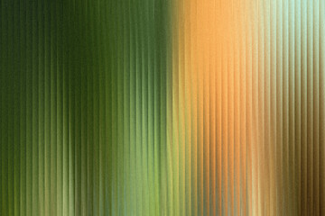 Obraz premium A textured abstract background features a gradient transition from deep green to warm orange, with vertical ribbed lines creating a sense of depth and movement