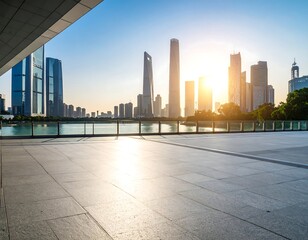 Empty plaza overlooking a modern city skyline at sunrise