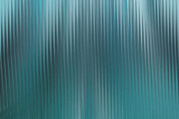 A textured background with vertical ribbed lines in shades of teal and blue, creating a sense of depth and abstract pattern
