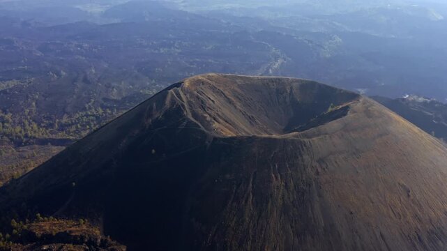 DRONE: ORBIT AND ZOOM OUT SHOT OF THE CRATER OF THE PARICUTIN VOLCANO IN THE EARLY MORNING